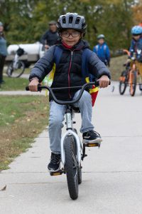 Young boy riding his bike toward the camera