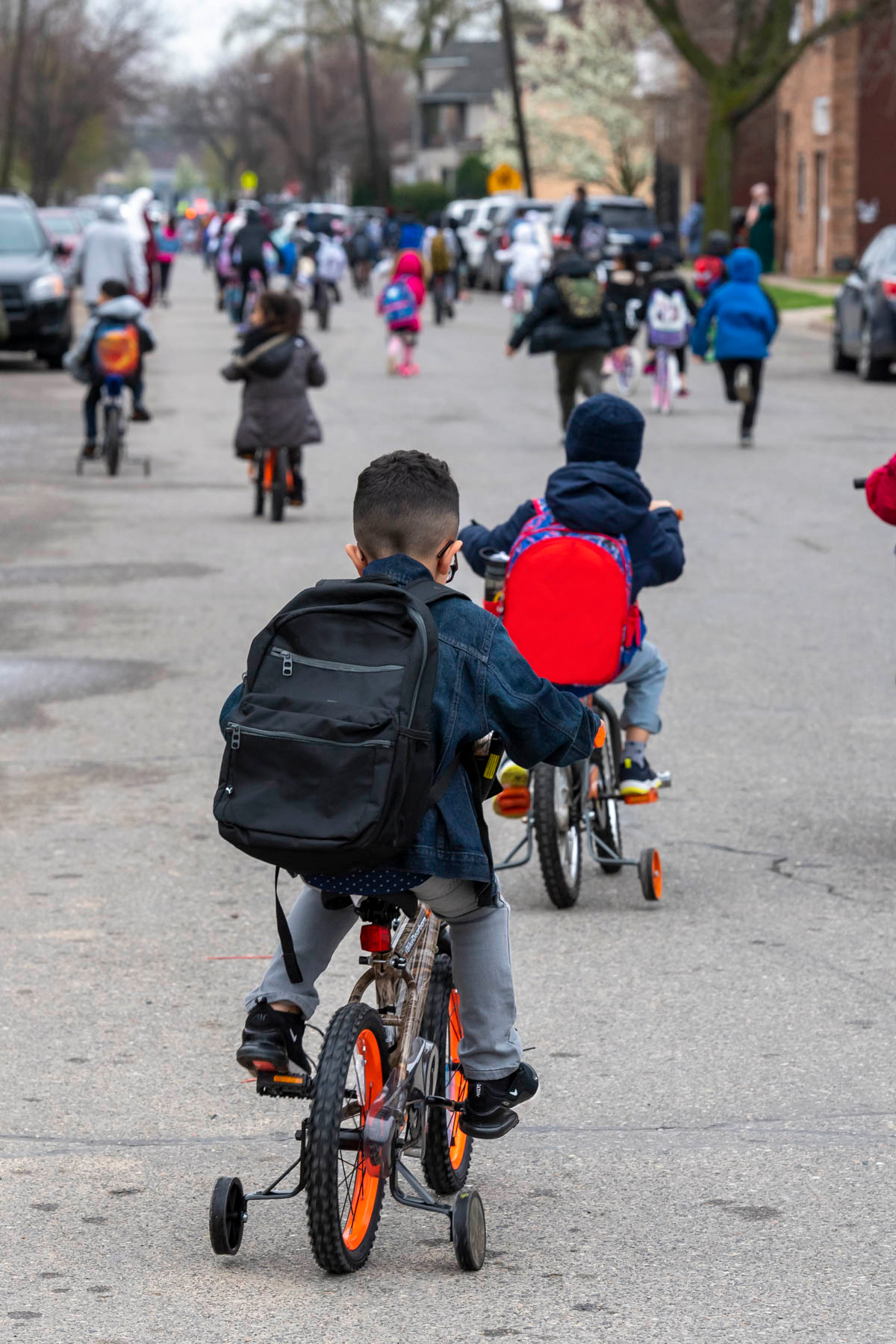 Two children are riding their bikes to school
