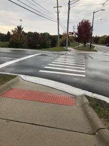 ADA crossing improvements with high vis crossing striping and vehicle stop bar step back from the crossing space