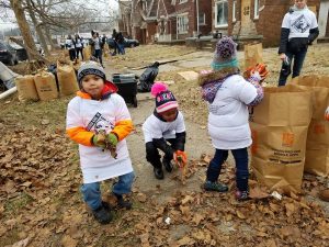 Kids are cleaning leaves in a fall 