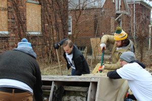 Volunteers dispose of a couch, CMA Board-UP