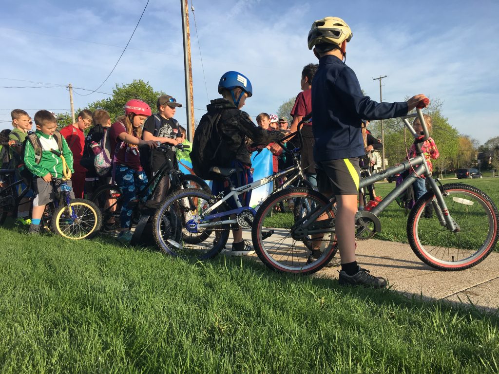 a line of students on bikes prepares to leave Klager Elementary in Manchester as part of Bike to School Day.