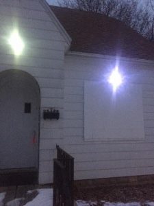 two lights used to illuminate boarded up house along school route