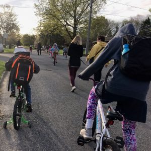 Students with helmets biking in Hastings, MI with their parents/supervisor 