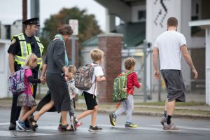 Students with backpack and parents participating walking to school.