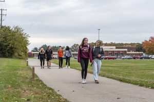 Surrounded by fall foliage, student stake the new multiuse path on their school commute