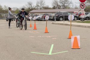 Students line up and move through an obstacle course of bike skills as part of Portland Bike Rodeo event which is part of SRTS programming.