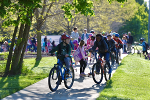 Bennett Wood students arrive at school on bikes and scooters as part of Bike and Roll to School Day. Photo Credit MDOT
