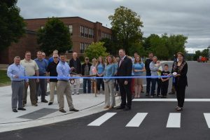 Officials attend a Safe Routes to School ribbon cutting event in front of East Jordan School at the bulb out crossing.