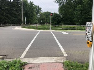Crossing improvements at Airport Road and Herbison with two white parallel lines across the street 