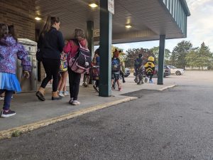 Walking school bus of students and parents walk from a remote drop location.