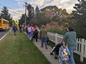 A group of community members and students participating in the Bath Walk and Roll to School Day.