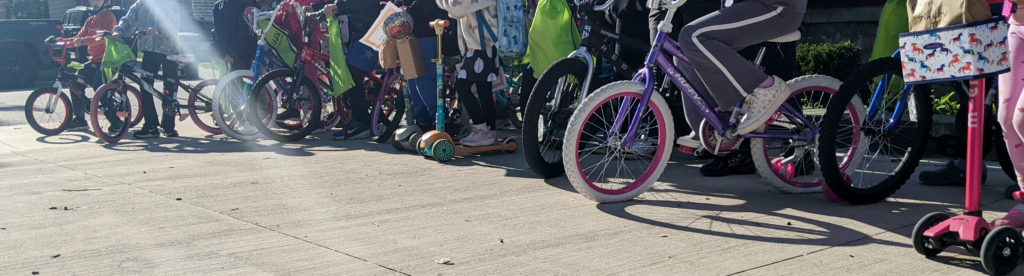 Wheels of bikes and scooters lined up by students who particanted in Walk and Roll to School Day event in Dearborn.