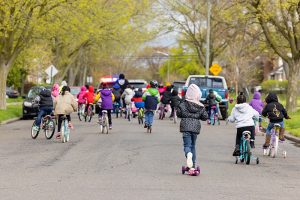 Kids biking down the street during Bike and Roll to School