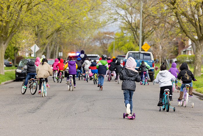 Kids biking down the street during Bike and Roll to School