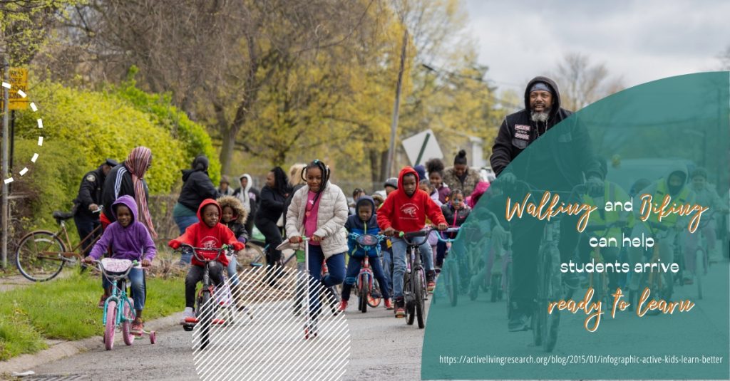 Bunch of kids are biking to school under the supervision of their parents and supervisors 