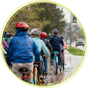 Group biking to school in the rain